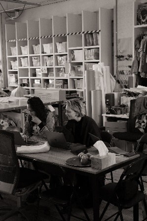Courtney Holm and project partner Dewi Cooke from The Social Studio, putting deadstock listings up. Photo by Lily Clatworthy 
