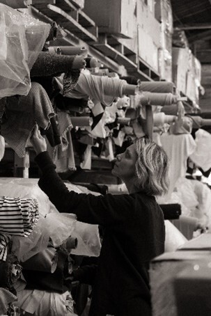  A.BCH Founder Courtney Holm, browsing deadstock fabrics that are currently stored in warehouses across Melbourne. Photo by Lily Clatworthy