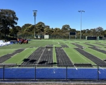 Hockey field, VIC. Turf is sliced into strips for machinery to roll up into rolls.