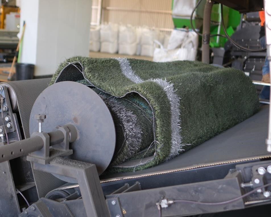 Rolls are run through the beater machine to remove sand and rubber infill.