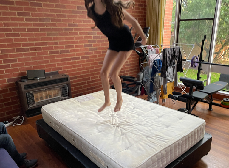 Girl jumping on mattress on top of ROBOBED base