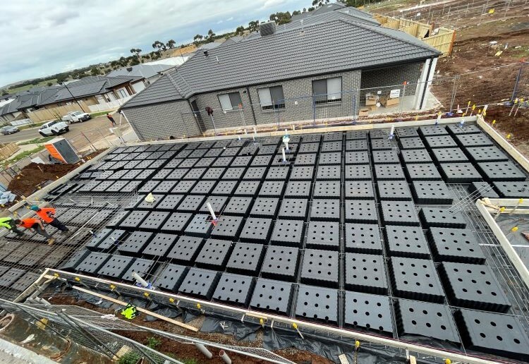 grey single storey house next to rows of Cleva Pods